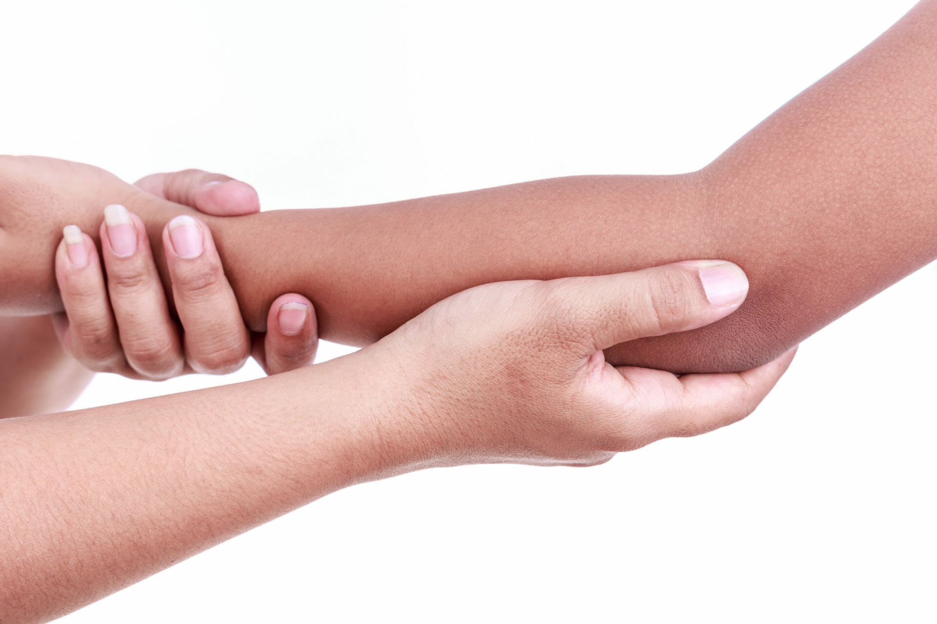 Close up of a woman's hand holding children's elbow