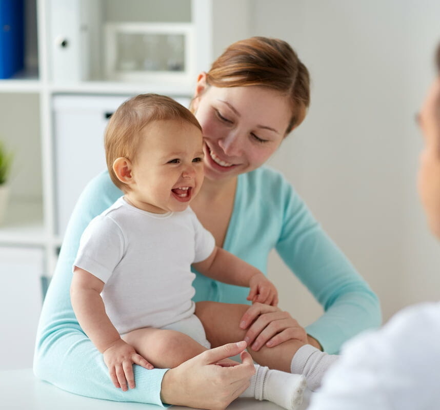 A baby laughing during a check up