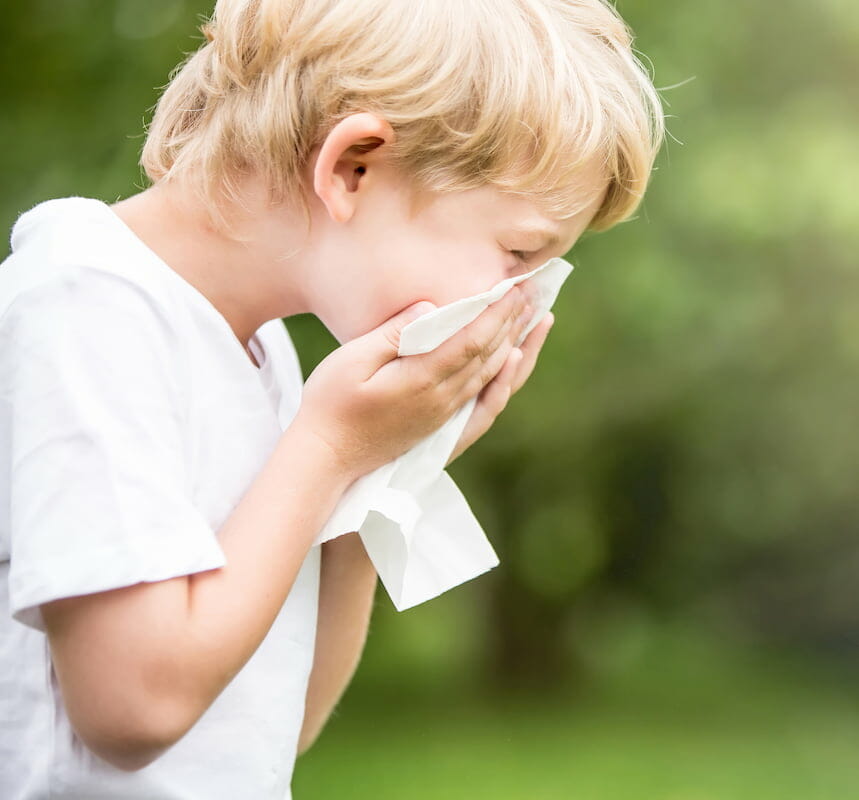 a child blowing his nose
