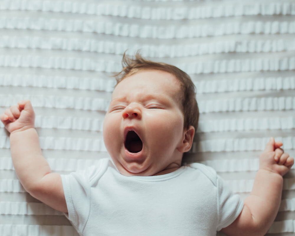 a newborn baby yawning