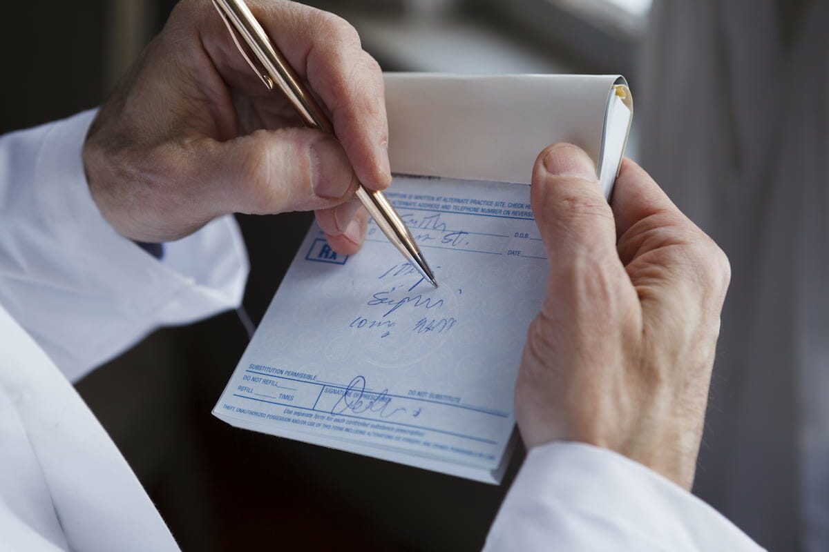 a pharmacist signing a prescription