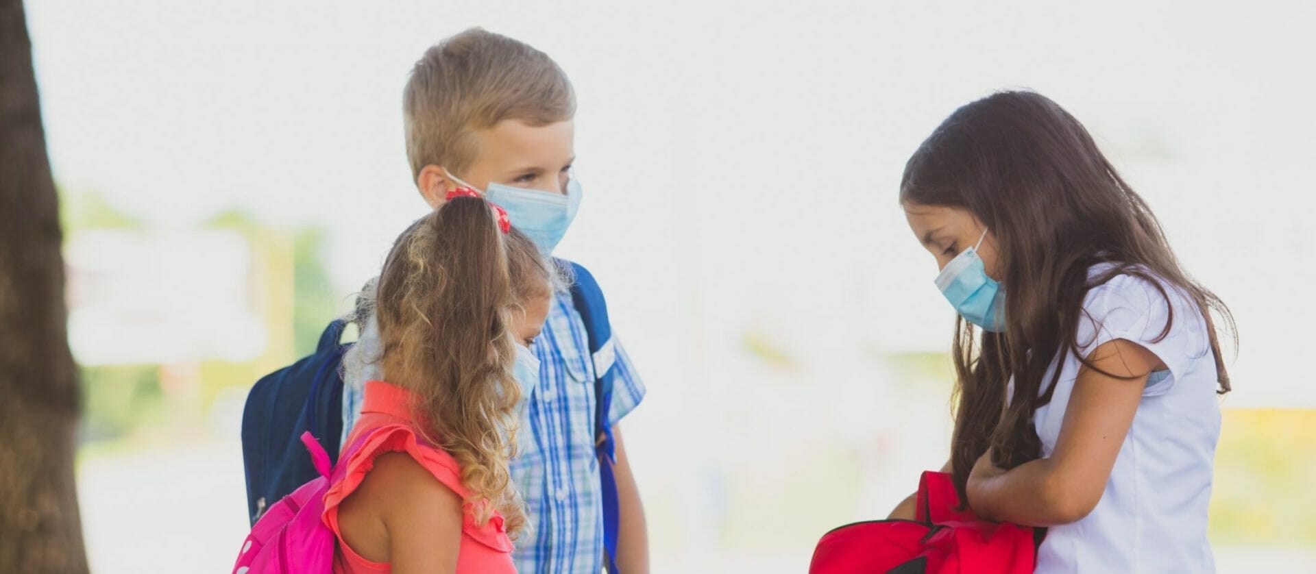 3 children with masks on